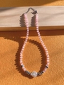 Close-up of pink cat eye stone beads necklace with silver spacer beads and white pendant - Baroque Style Pink Cat's Eye 38+5cm
