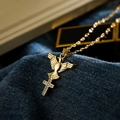 Gold angel cross pendant necklace with clear zircons on dark denim background - Gold Dove Cross