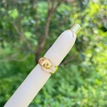 Elegant 18K gold plated belt buckle ring with sparkling cubic zirconia on a beige stand - Belt Buckle Style