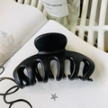Detailed view of a large matte black flower hair claw clip on a white magazine background - Keel Style Claw / Approx 11cm / Matte Black