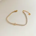 Gold stainless steel tennis bracelet with zircon accents and a central round stone - Stainless Steel/Zirconia / Gold Round Main Stone Style (SBK170)