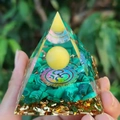 Orgone pyramid with green malachite stone and Om symbol held in hand outdoors - 5cm / A16-Malachite Om Symbol