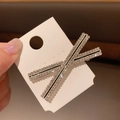 X-shaped silver metal hair clip with sparkling rhinestones and black line accents - Cross Bow