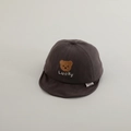 Close-up of baby peaked cap with brown bear embroidery and Lucky text on soft cotton - 50cm 1-2 Years / Brown