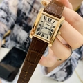 Close-up of a ladies rectangular gold watch with brown crocodile leather strap on a wrist - Rose Gold Case Brown Leather
