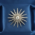 Vintage silver sunburst brooch with wavy rays on blue silk fabric backdrop - Sunbeam Style (XD7507)