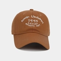 Detailed view of white embroidery on a dark brown cotton twill baseball cap - Adjustable / Caramel color