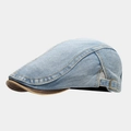 Detail of blue denim ivy cap with brown leather trim and bronze metal buckle - Adjustable / Light Blue