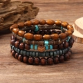 Multilayer wood bead bracelet set with turquoise stones on a natural wooden desk - Gravel 5-piece Set