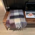 Detailed view of colorful rainbow plaid scarf with soft tassels on a wooden surface - Purple Gray Beige Coffee Check
