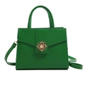 Emerald green crossbody bag with elegant floral gold clasp and leather texture - Green