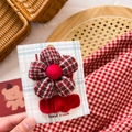 Detail of handmade red and green plaid fabric flower hair clip with a bow on display card - Red & Green Plaid Flower Set 2Pcs