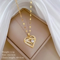 Close-up of gold heart pendant with weight and size specs on a soft silk background - Hands Holding Heart Style (B413)