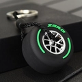 F1 racing tire keychain with black rubber, silver hub, and green Zero branding - Green