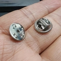 Macro shot of silver metal pin back clutch being held in palm to show actual small size - Stainless Steel Butterfly Clutch (11.7x5mm)