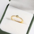 Macro shot of gold-plated brass ring with zircon inlay in a green velvet jewelry box - Letter O Gold