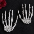 Close-up of realistic ivory plastic skeleton hands on a dark textured background - Original Color