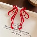 Macro view of red bow earrings with sparkling crystal center on a white vintage plate - Red (S925 Sterling Silver Pin)