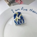 Blue and yellow marble texture acetate hair claw clip on a white decorative plate - Blue