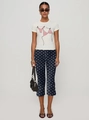 Detail of navy blue polka dot cropped pants featuring a stylish side slit at the hemline - S / Navy Blue