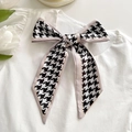 Classic houndstooth skinny scarf with pink trim tied in a bow on a white shirt - Khaki Border Houndstooth