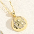 Macro shot of gold Virgin Mary pendant with sparkling white crystals and cross chain - Semicircle Virgin Mary (Gold)