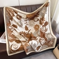 Detail of silk square scarf featuring floral patterns draped on a brown leather sofa - 90*90cm / Dark Brown