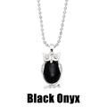 Macro detail of silver owl pendant featuring a large oval black onyx stone inlay - Black Agate