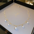 Detailed view of elegant gold plated pearl necklace on a premium gray jewelry display box - Gold Multi-layer Pearl Style (Real Gold Plated)