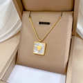 Gold square shell pendant necklace with heart detail in a beige jewelry box - Square MOP Heart Gold (N201)