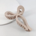 Matte nude pink bow-shaped hair claw clip made of resin on a white background - Matte Milk Tea