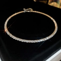 Macro shot of silver tennis necklace with sparkling round zircon on black velvet - Silver-Single Row