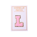 Detail of pink chenille letter L patch with gold glitter edge and peel-and-stick backing - Letter L