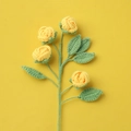 Detail of four handmade yellow crochet roses with green leaves on a bright yellow background - Finished Bubble Roses (4 Heads Yellow)