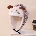 Close-up of pink winter trapper hat with cartoon prints and plush lining details - Children 3-10 Years Old / Pink Cartoon