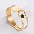 Moderno bracciale rigido in acciaio inossidabile dorato con elemento decorativo nero - Oro