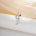 Sparkling silver stud earring with green star crystal and small clear stones on a white stand - Mint Green Star Meteor Style (A888-3)