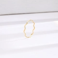 Minimalist gold wavy stackable titanium steel ring with polished finish on white surface - Ultra-thin Wave Gold