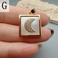 Detailed close-up of a square gold pendant with mother of pearl and zircon moon inlay - Crescent Moon