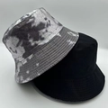 Close-up of stacked cotton bucket hats in tie-dye grey and solid black with detailed stitching - Tie-dye Grey 2-Piece Set (18)