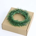 Mini green PVC pine needle Christmas wreath candle ring displayed on a brown box - 6cm Green Pine Needle Ring