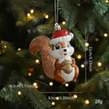 Glittery squirrel Christmas tree ornament with red sequin hat and golden acorn charm - Squirrel Style