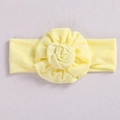 Soft knitted yellow baby headband featuring a large 3D floral knot design - Yellow