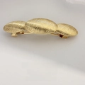 Elegant gold hair clip with three oval links and refined brushed metal texture - Ribbed Triple Oval Gold