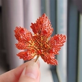 Elegant gold maple leaf brooch with vibrant red and orange crystal rhinestones - Gradient Red