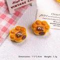 Detailed macro view of an orange cat paw resin charm for DIY crafts and jewelry making - Cat Paw Bread-Chocolate Flavor