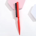 Detailed macro view of the professional red hair styling brush with mixed nylon and boar bristles - Plastic / Red