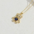 Gold bear pendant necklace featuring a large blue heart gemstone and zircon pavé accents - Royal Blue Heart (XL2572-2)