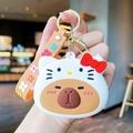 Brown Capybara and Hello Kitty silicone keychain with orange strap and gold metal ring - Hello Kitty Capy Purse