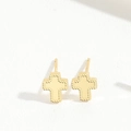 Detail of gold cross stud earrings featuring an S925 silver hallmark on white texture - Cross Style / Gold